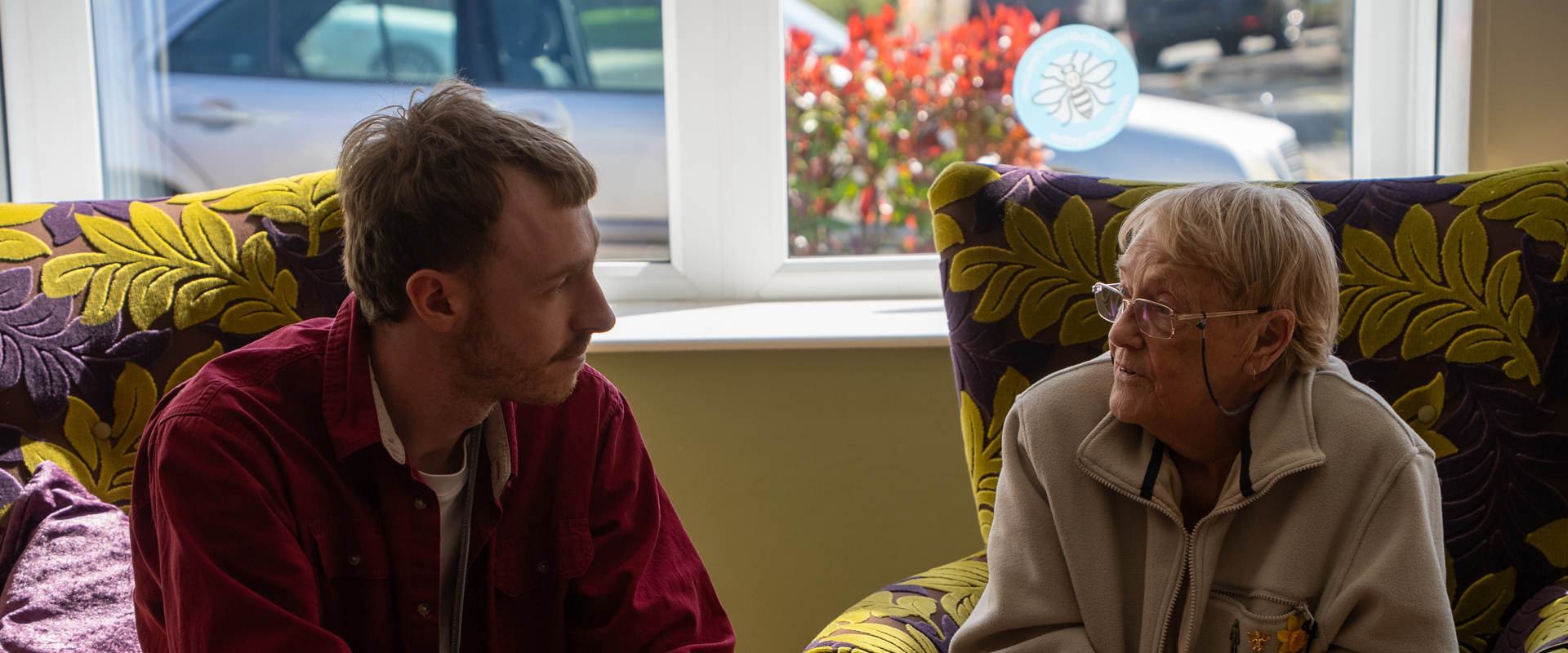 Two people in chairs having a discussion.