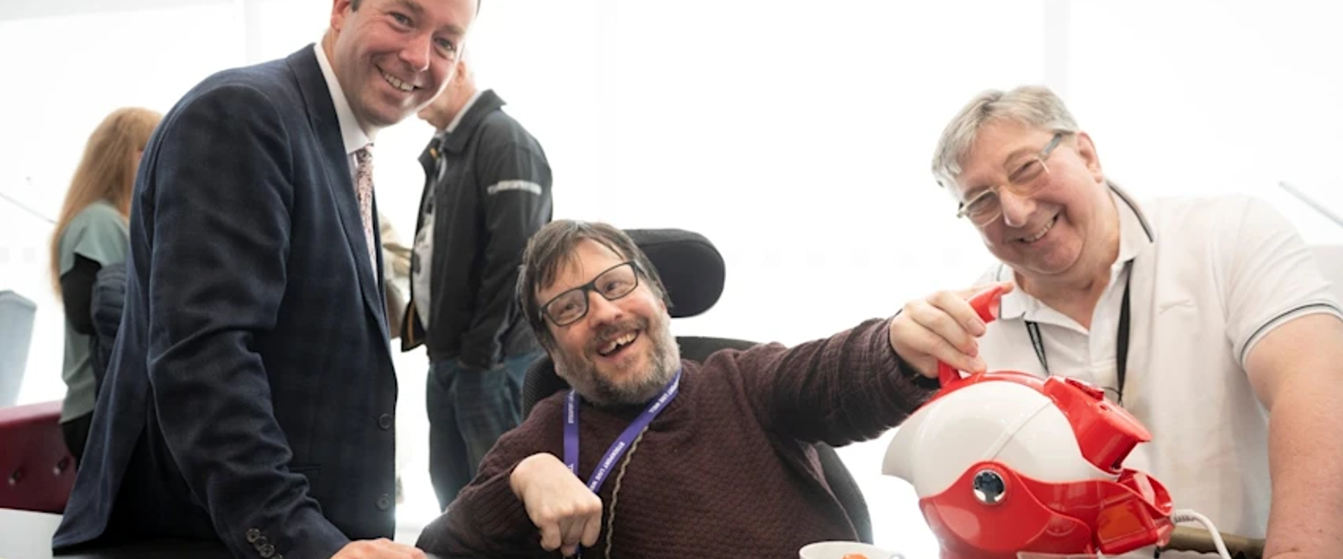 Council Leader Cllr Mark Roberts with Richard Currie and Robert Norton, Stockport Council, trying out some of the assistive equipment at the Live Well Independently in Stockport Suite.